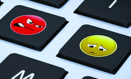 An angry and sad face on the keys of a keyboard