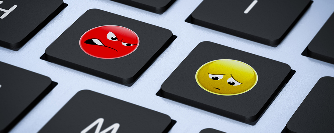 Keyboard keys with an angry and sad cartoon face on them
